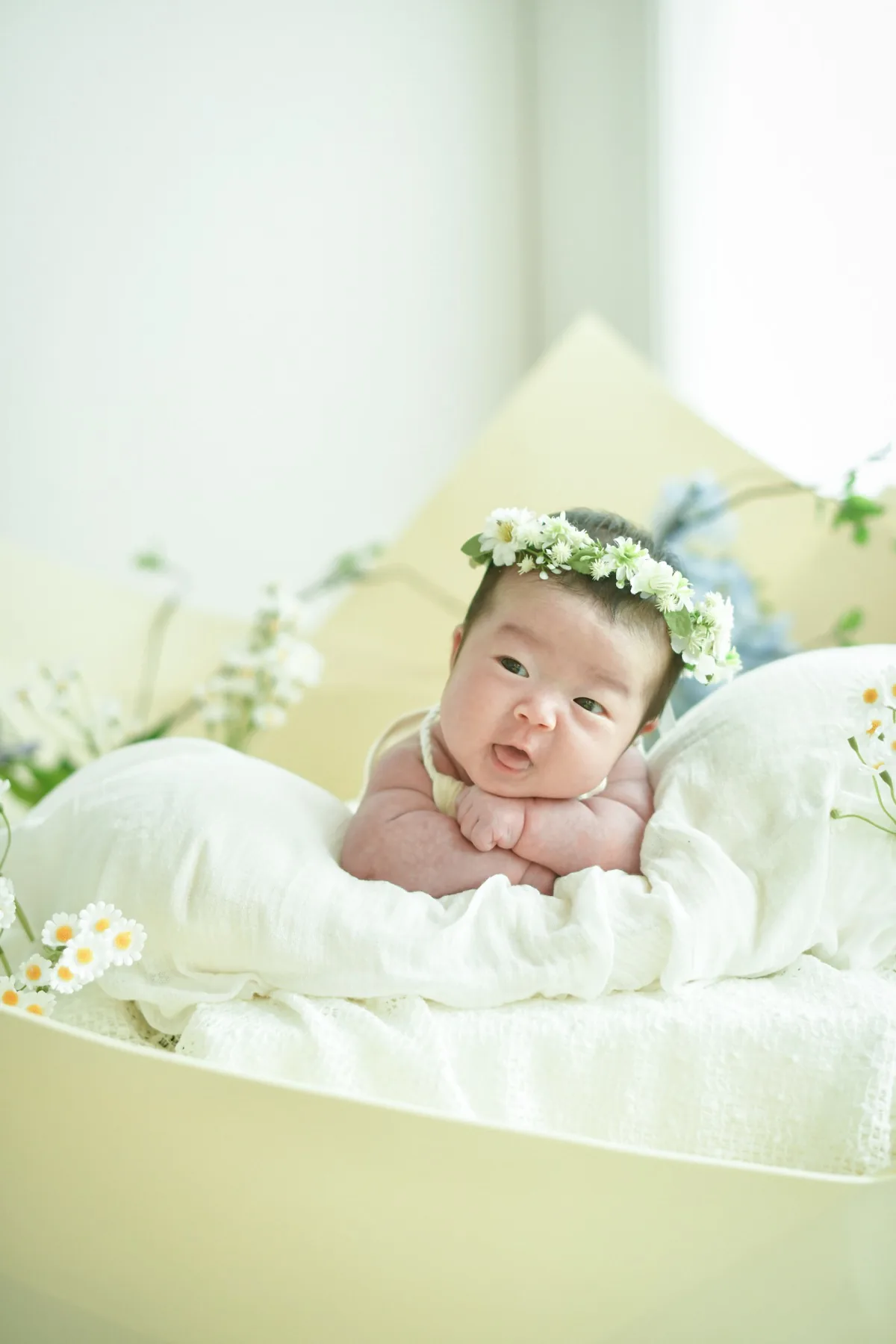 하얀 꽃관을 쓰고 포근한 이불에 엎드린 신생아 하름이